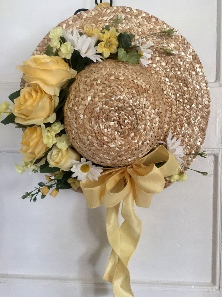 a straw hat decorated with flowers and ribbons