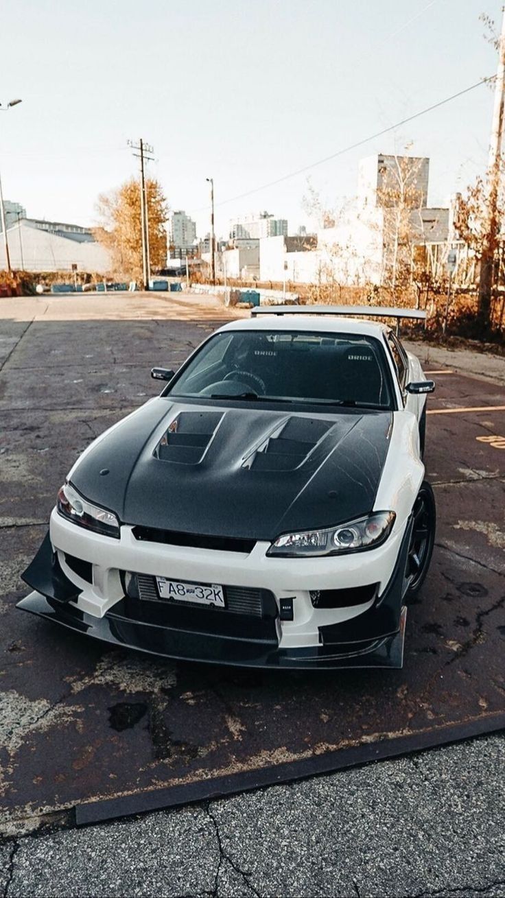 a black and white sports car parked in a parking lot