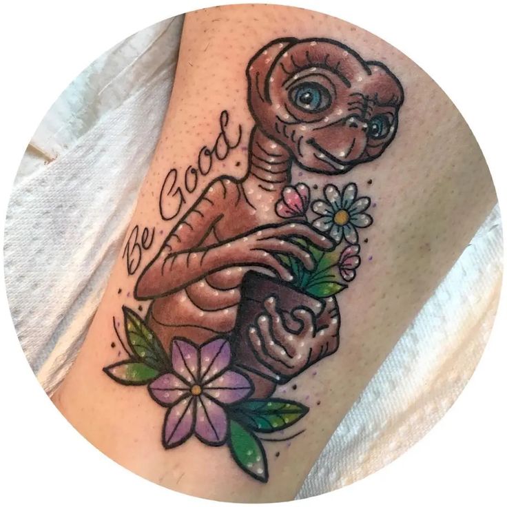 a tattoo with an image of a snake and flowers