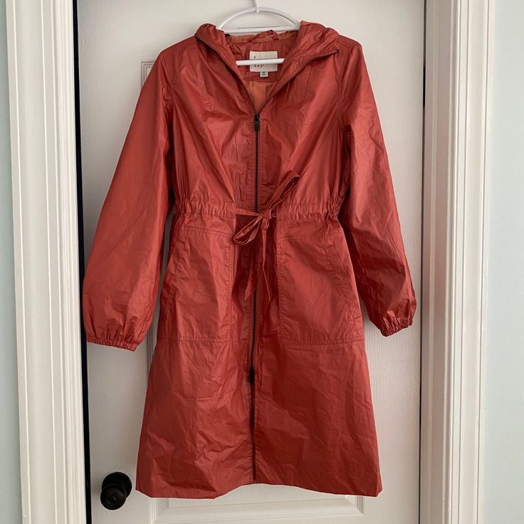 Adorable Hooded Raincoat/Windbreaker. Oversized, Very Roomy. Zip Front And Belted. Elastic Sleeve Bands. Beautiful Coat! ***Size Xs But Fits More Like A M-L*** Please Note: Tag Xs But Fits M-L Long Sleeve Raincoat For Cold Weather Spring, Spring Cold Weather Long Sleeve Raincoat, Spring Long Sleeve Cold Weather Raincoat, Long Sleeve Parka For Rainy Fall Weather, Fall Parka For Rainy Weather, Fall Rainy Weather Parka, Long Sleeve Weatherproof Raincoat For Fall, Weatherproof Long Sleeve Raincoat For Fall, Spring Parka For Rainy Weather With Long Sleeves