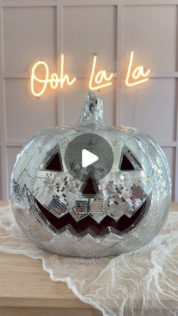 a shiny pumpkin with the words oh la la lo on it's front and side