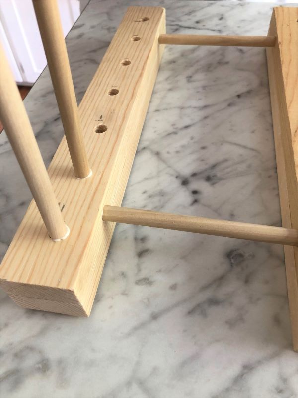 a close up of a wooden object on a marble counter top with holes in it