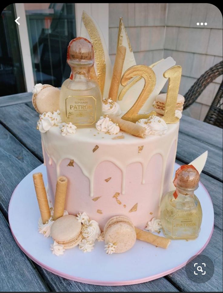 a birthday cake decorated with perfumes and cookies