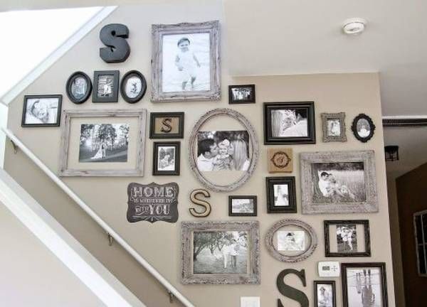 the stairs are decorated with many pictures and letters on them, as well as framed photos