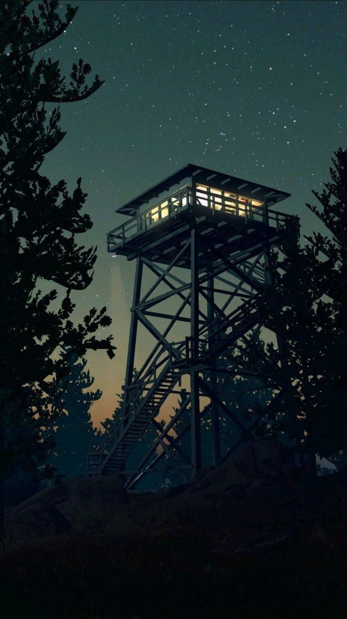 a tall tower sitting next to trees under a night sky