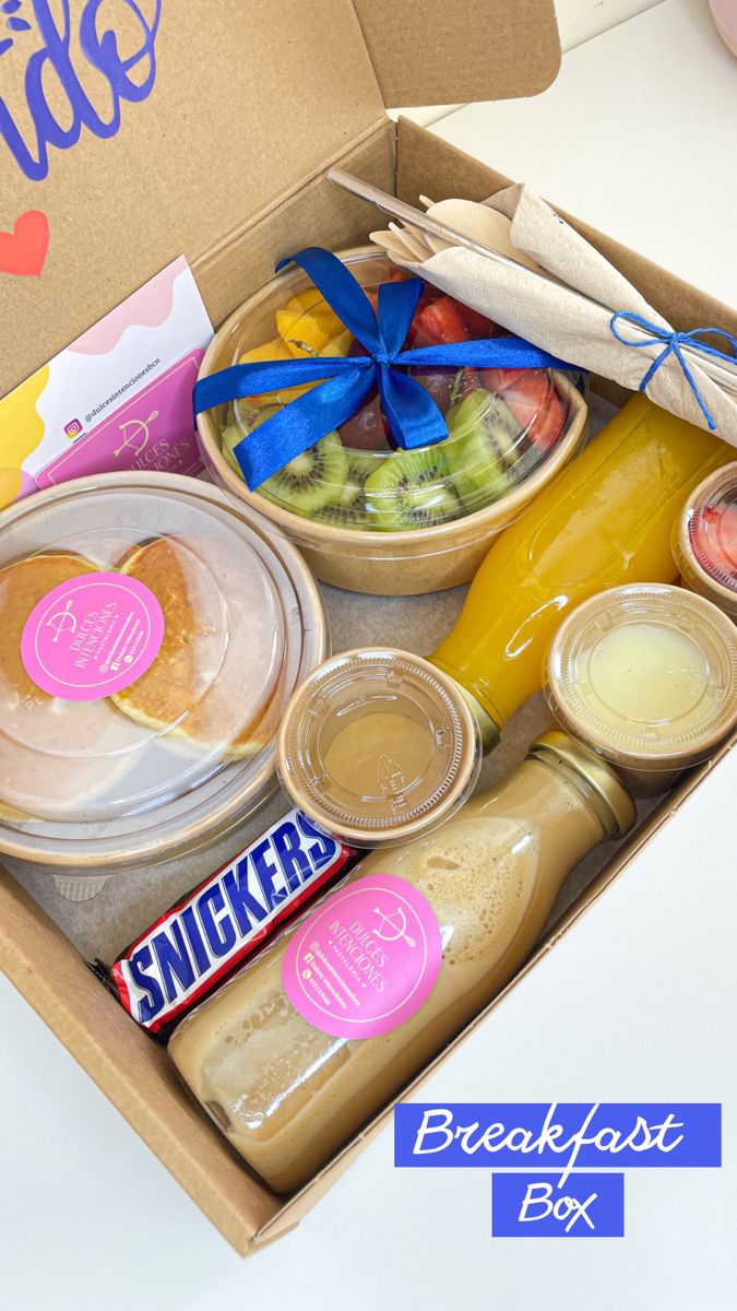 an open lunch box filled with snacks and condiments