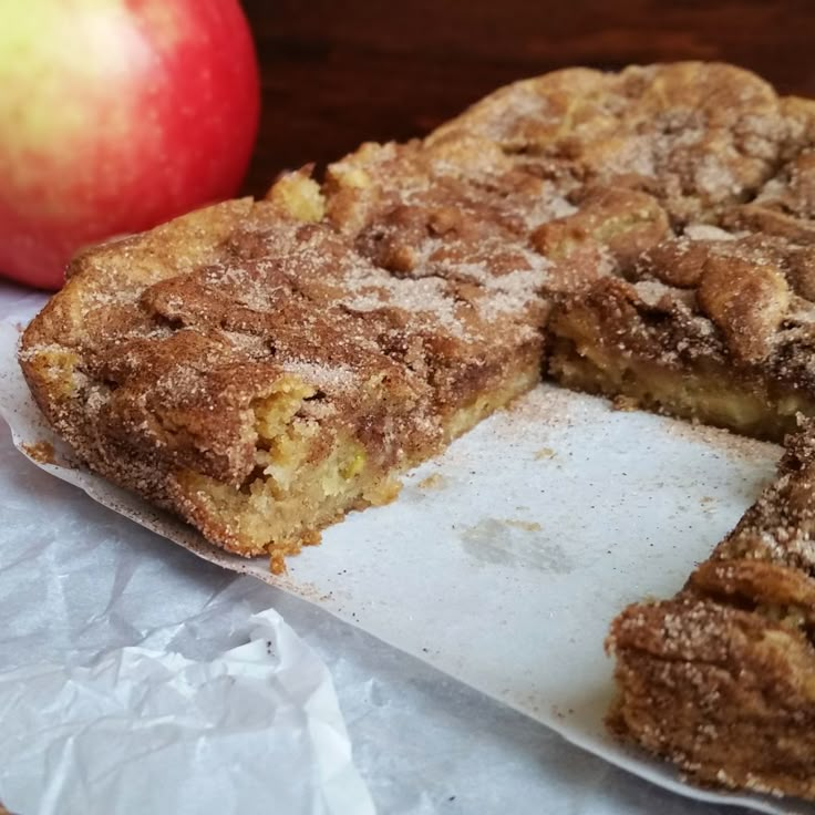 an apple pie is cut in half and on top of the paper next to it