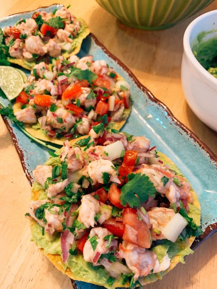 two tortillas filled with meat and veggies on a table