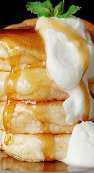 a stack of pancakes covered in butter and syrup