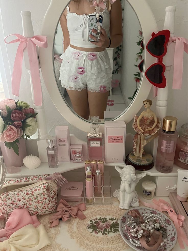 a woman standing in front of a mirror with lots of pink accessories around her waist