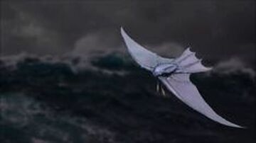 a large white bird flying over the ocean