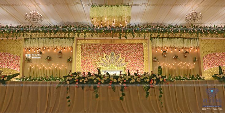 an elaborate stage decorated with flowers and greenery