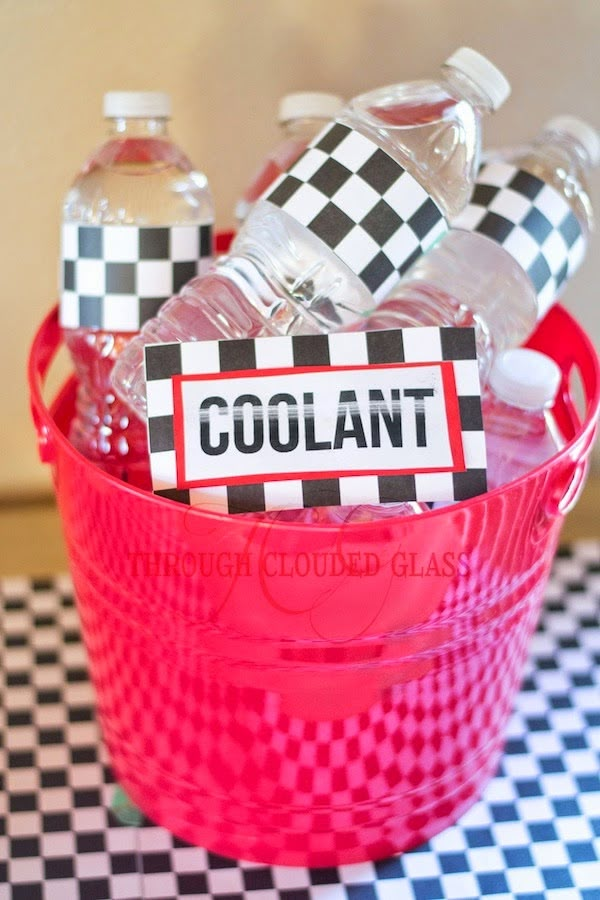 a red bucket filled with water bottles on top of a checkered table