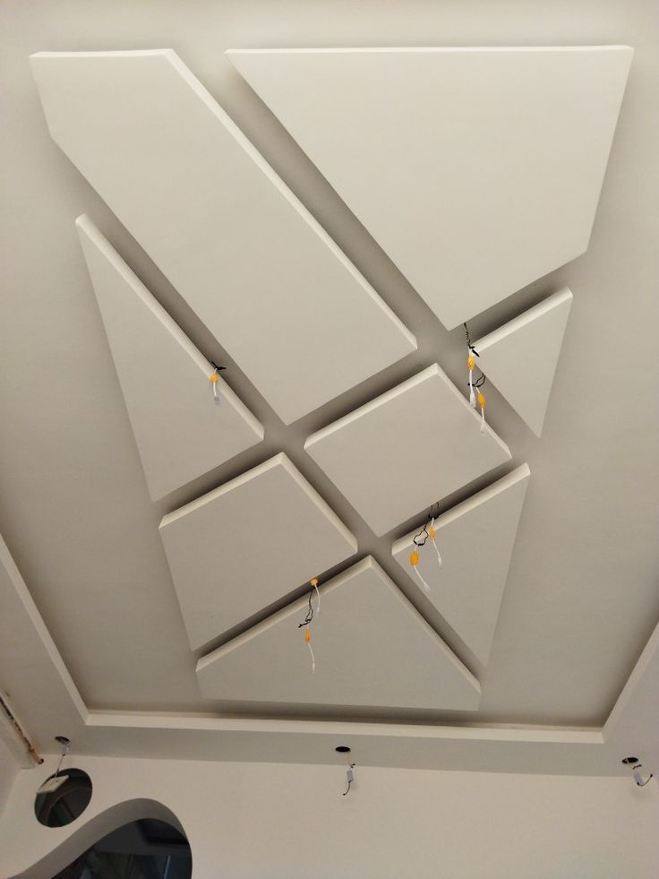 the ceiling is white and has several square shapes on it, with yellow beads hanging from them