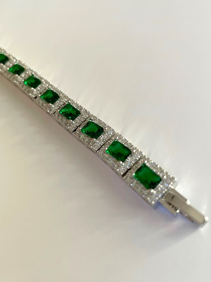 This rectangular zirconia bracelet features a durable platinum plating for a long-lasting shine. The stunning zircon stones add a touch of elegance, making it the perfect accessory for any outfit. Expertly crafted, this bracelet is both beautiful and resilient, providing a sophisticated addition to your jewelry collection. Rectangular Cubic Zirconia Bracelets, Classic Bracelets With Rectangular Cubic Zirconia Links, Classic Cubic Zirconia Bracelets With Rectangular Links, Classic Rectangular Cubic Zirconia Diamond Bracelet, Silver Tennis Bracelet With Emerald Cut Diamond Accents, Silver Emerald Cut Diamond Bracelet, Silver Emerald Cut Tennis Bracelet, Silver Emerald Cut Tennis Bracelet With Diamond Accents, Formal Rectangular Bracelet In Fine Jewelry Style