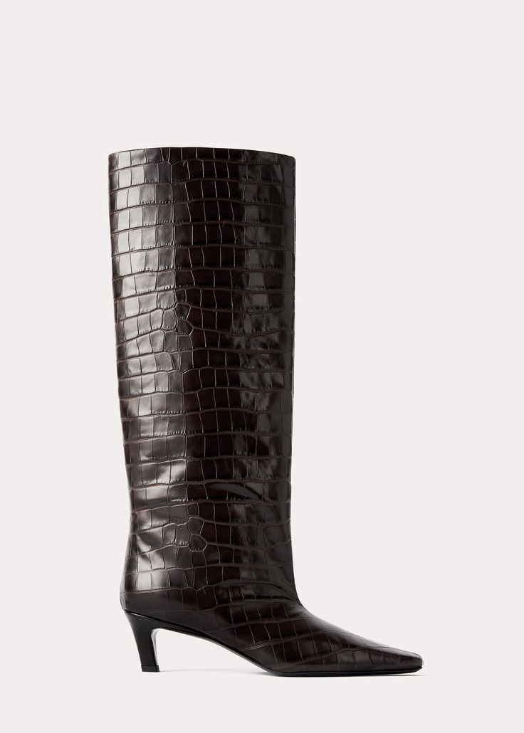 TOTEME boots named after their statement silhouette, outlined with a wide, tall shaft. They are crafted in Italy from crocodile-embossed leather with a squared point toe and a covered heel and are lined in soft leather. Wear them with midi dresses or tucked-in trousers. Wide Shaft Boots, Shaft Boots, Sheep Leather, Clutch Pouch, Leather Mules, Dark Brown Leather, Leather Care, Boot Sandals, Midi Dresses