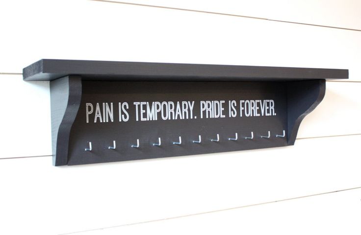 a sign on the side of a building that says pain is temporary pride is forever