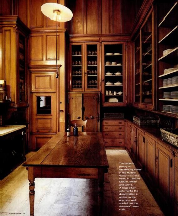 an old fashioned kitchen with wooden cabinets and wood flooring is shown in this image