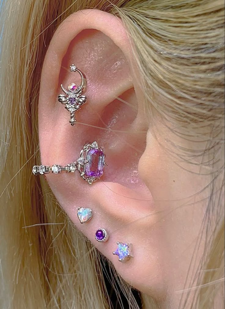 an ear with three different types of piercings on it