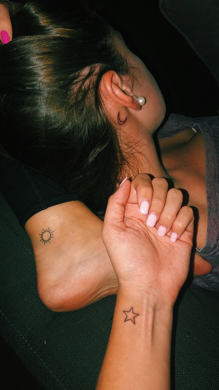 a woman with two small stars on her left wrist and the other half of her arm