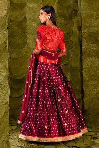 Plum maroon lehenga with silk tape, aari, zari and silk thread embroidery. Paired with an embroidered long blouse and a circular butti embroidered dupatta. - Aza Fashions Banarasi Silk Sets With Gota Work For Reception, Reception Banarasi Silk Choli With Gota Work, Banarasi Silk Choli With Gota Work For Reception, Reception Choli With Gota Work In Banarasi Silk, Reception Gota Work Banarasi Silk Sets, Red Gota Work Choli For Reception, Red Art Silk Dress With Cutdana, Red Cutdana Art Silk Dresses, Designer Red Tissue Silk Sharara