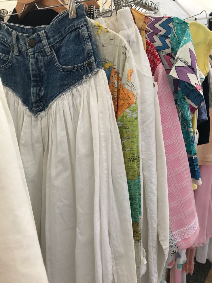 clothes are hanging on racks in a clothing store, with one woman's shirt pulled up to the side