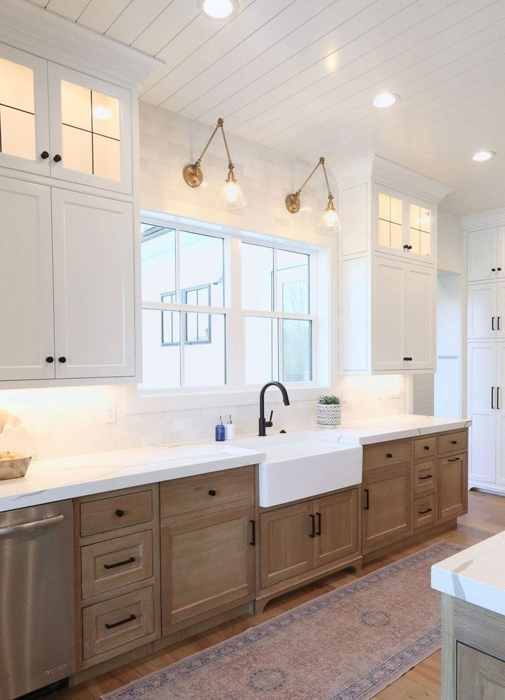 a large kitchen with wooden cabinets and white counter tops, along with a rug on the floor