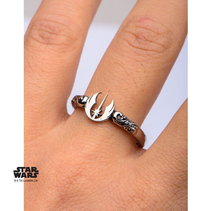 a woman's hand with a star wars ring on top of her finger,