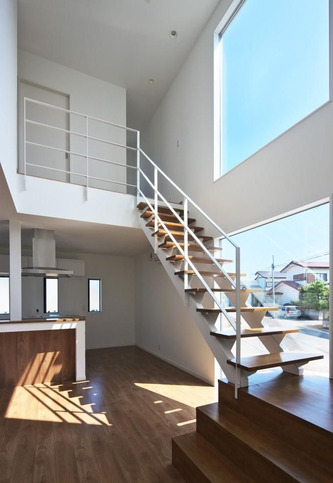 an open floor plan with stairs and windows