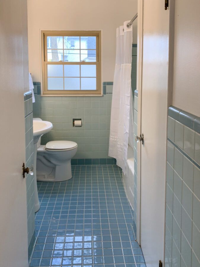 a bathroom with blue tile floors and walls