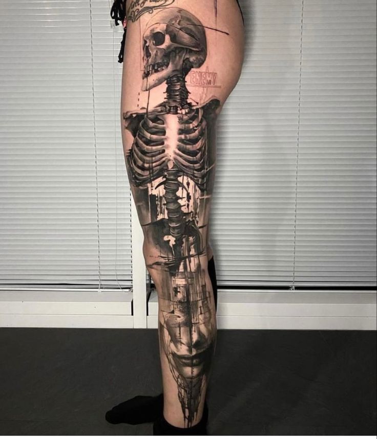 a person with a skeleton tattoo on their leg