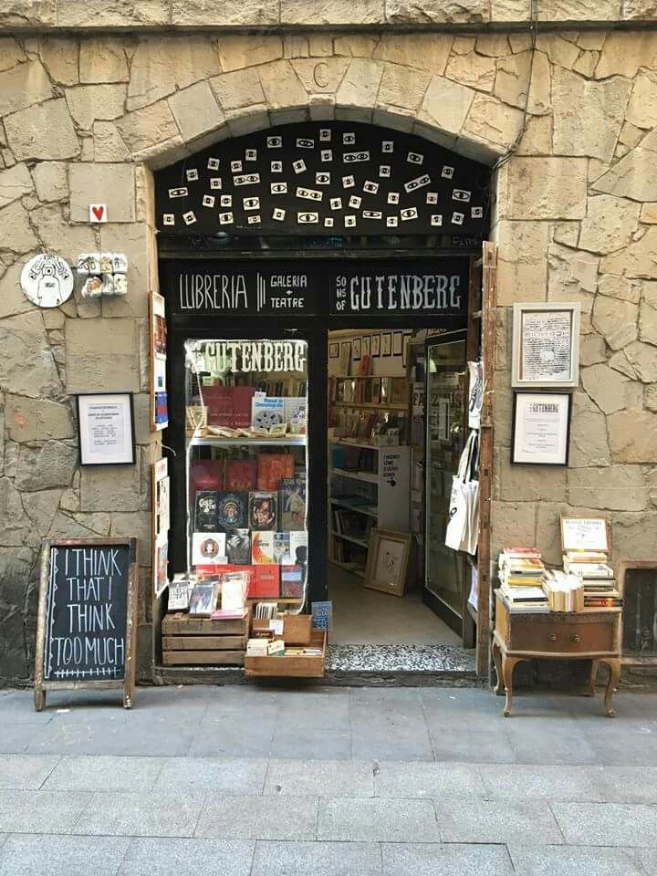 an open door to a book store on the side of a building with many books