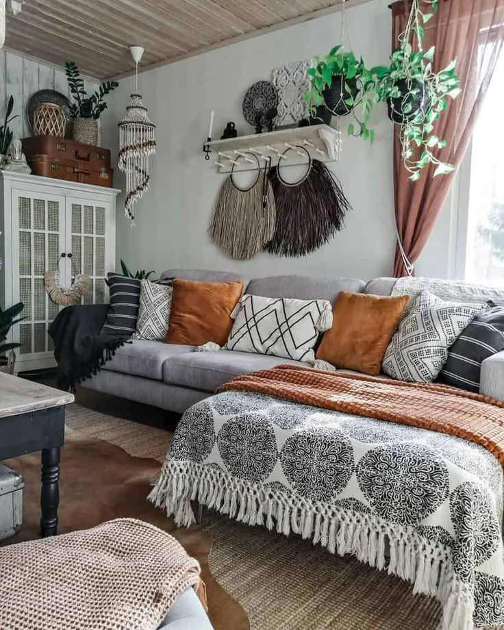 a living room filled with lots of furniture next to a window and potted plants