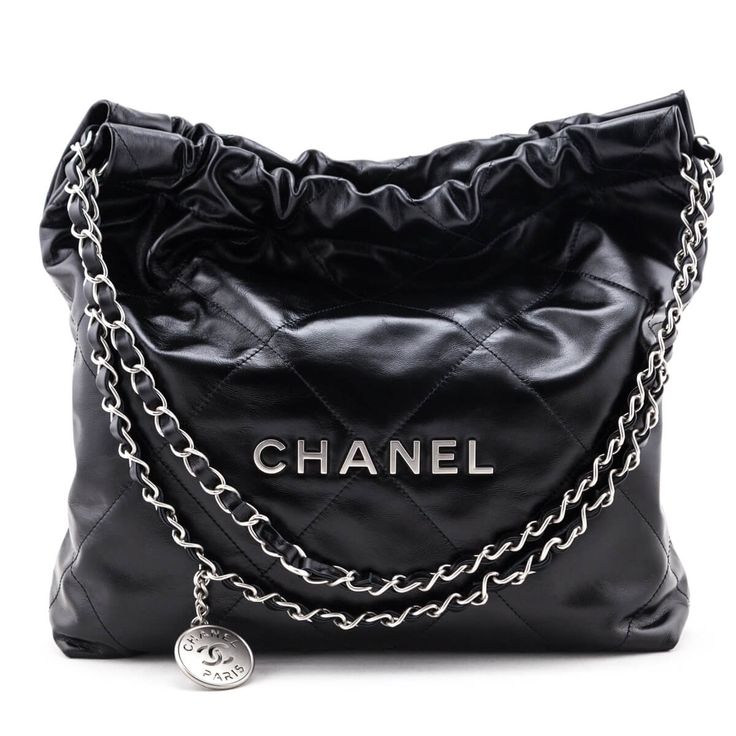 Irreverent cool with luxury finishing touches, this pristine Chanel 22 Bag is the current model you've been searching for! The high shine black calfskin exterior is finished with oversized flat diamond quilting, and matte silver-tone hardware. Front and center, individual hardware letters spell out CHANEL, set below the double interwoven leather & chainlink straps with a hanging branded medallion for added impact. The lightly cinched top, flat base, and soft structure create an edged up paper ba Chanel 22 Bag, Cinched Top, Chanel 22, Louis Vuitton Multi Pochette, Chanel Set, Versace Style, Louis Vuitton Capucines, Authentic Designer Handbags, Chanel Purse