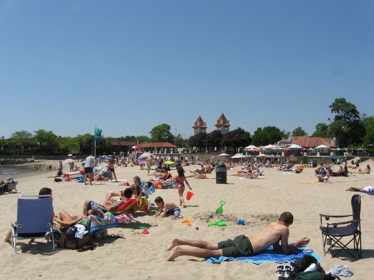 many people are relaxing on the beach