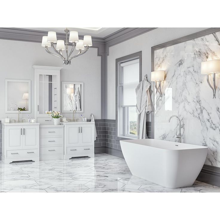 a large white bathroom with marble floors and walls, along with a freestanding tub