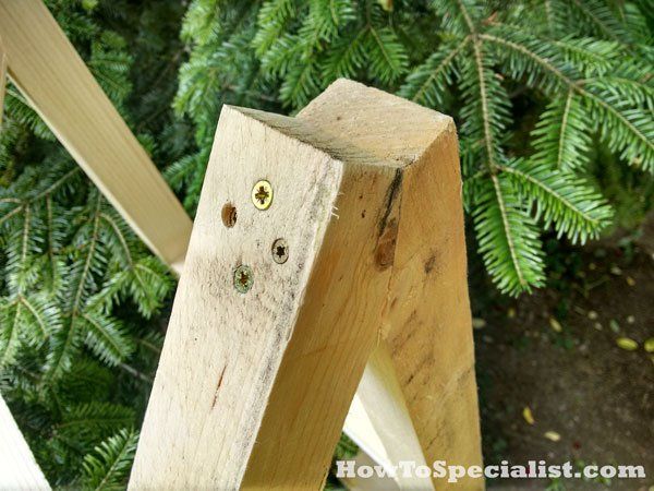 a wooden object sitting on top of a tree