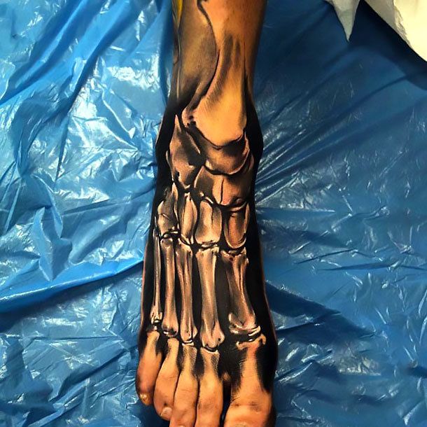 the foot is covered in black ink and has an intricate design on it's toes