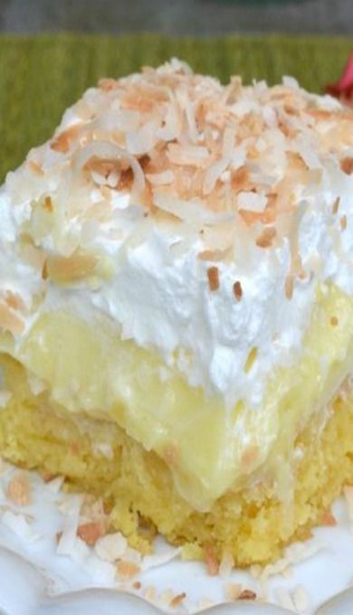 a close up of a piece of cake on a plate with whipped cream and toasted coconut