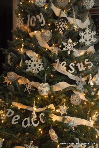 a christmas tree decorated with white and silver ornaments