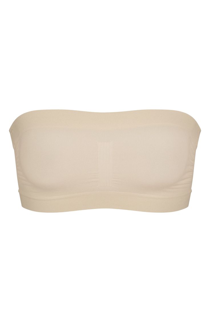 Designed to disappear under clothes, this strapless bandeau from Kim Kardashian's SKIMS supports and defines your bust while smoothing your back. Removable, adjustable straps 82% nylon, 18% spandex Machine wash, tumble dry Made in Turkey Strapless Nylon Tube Top With Built-in Bra, Strapless Tube Top With Built-in Bra, Solid Color Bandeau Shapewear, Smoothing Bandeau Solid Tube Top, Solid Smoothing Bandeau Tube Top, Smoothing Solid Bandeau Tube Top, Strapless Seamless Shapewear, Micro-elastic Strapless Bra-friendly Tube Top, Solid Strapless Smoothing Tube Top