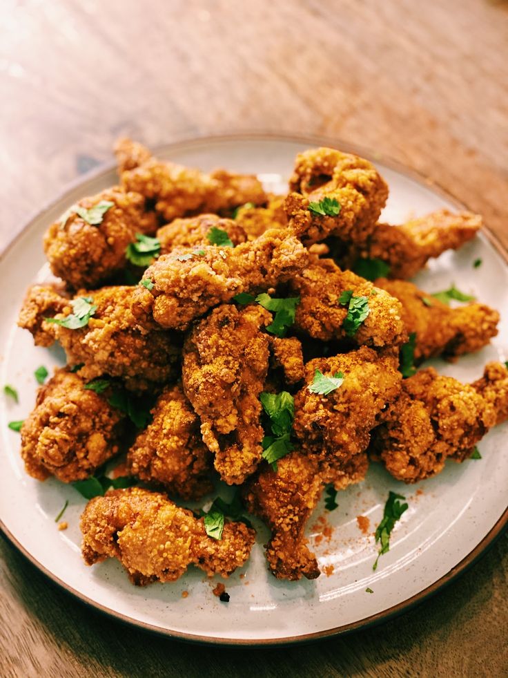 fried food on a white plate with parsley