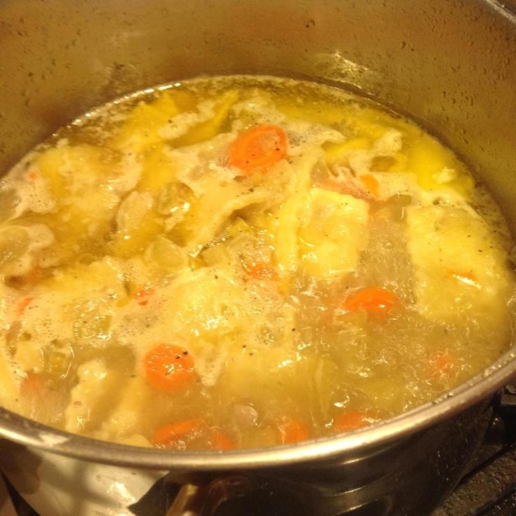 a pot filled with soup sitting on top of a stove