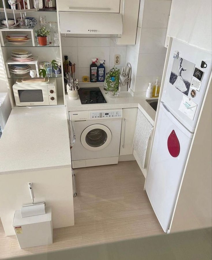 a small kitchen with white appliances and cabinets