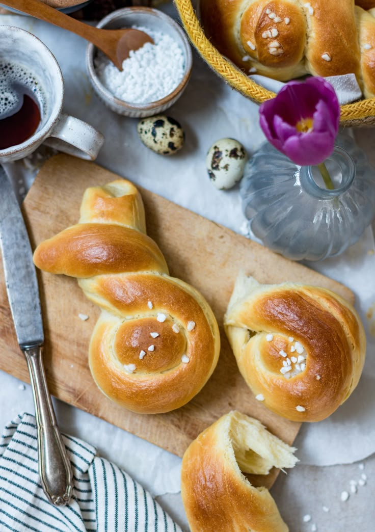 some bread rolls are on a cutting board