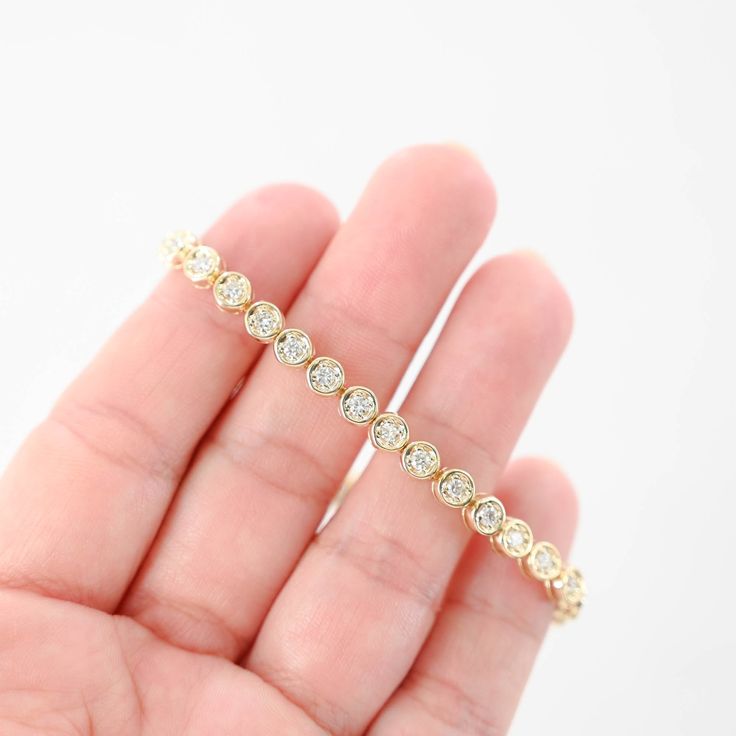 Featuring a total carat weight of 1.44. Crafted to perfection, this bracelet sparkles with every movement, making it a luxurious addition to any jewelry collection or a stunning gift for someone special. Bracelet length: 7"Bracelet width: 5 mmClosure style: Tennis claspMaterial: 14K Yellow GoldWeight: 13.9gDiamonds: 36 x 0.04Ctw = 1.44CtwColor And Clarity: G-H/SI1Total Carat Weight: 1.44Ctw For more of our jewelry products, please visit our shop 777jewelry Free shipping on all orders within the USA. International shipping available. We only sell real gold jewelry. We do not sell gold plated or gold filled jewelry. We offer a 30 day money back guaranteed return on all orders. Our goal is to make every customer satisfied. Fine Jewelry Tennis Bracelet With Bezel Setting, White Gold Cubic Zirconia Diamond Bracelet With Bezel Setting, Round Tennis Bracelet With Bezel Setting For Wedding, Bezel Set Round Tennis Bracelet For Wedding, Luxury Tennis Bracelet With Bezel Setting, Fine Jewelry Diamond Bracelets With Channel Set, Wedding Round Tennis Bracelet With Bezel Setting, Luxury Diamond Bracelet With Bezel Setting, Yellow Gold Diamond Bracelet, Channel Set