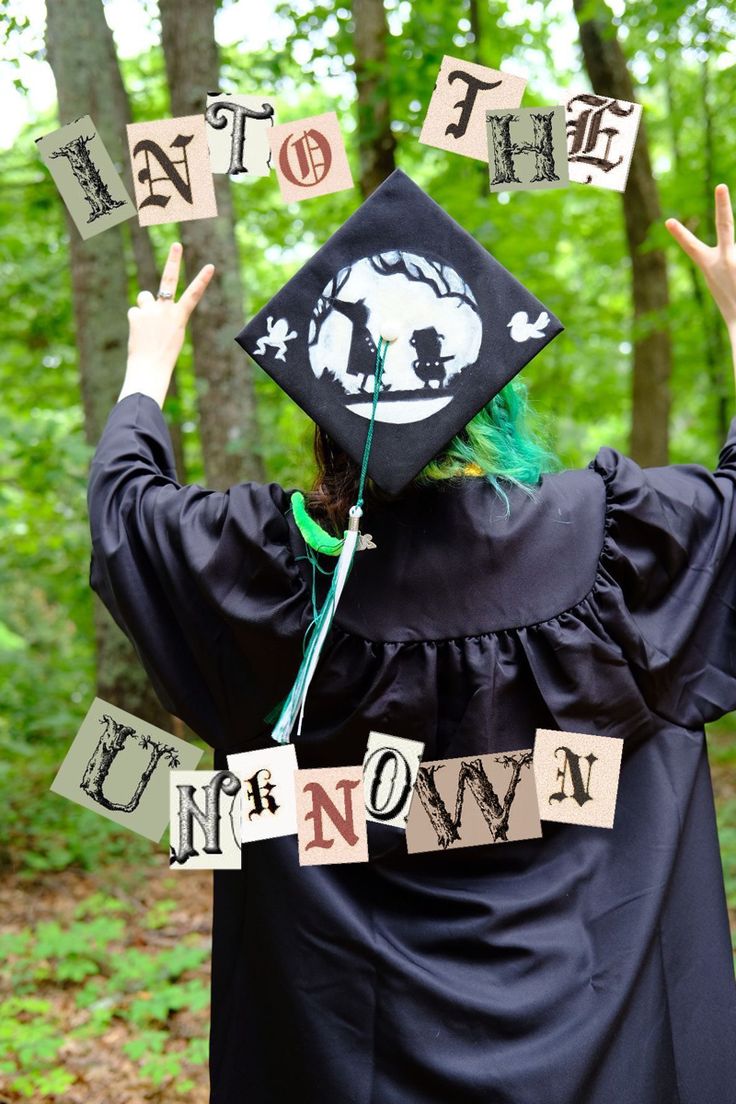 a person wearing a graduation cap and gown with letters that spell out the word i'm now