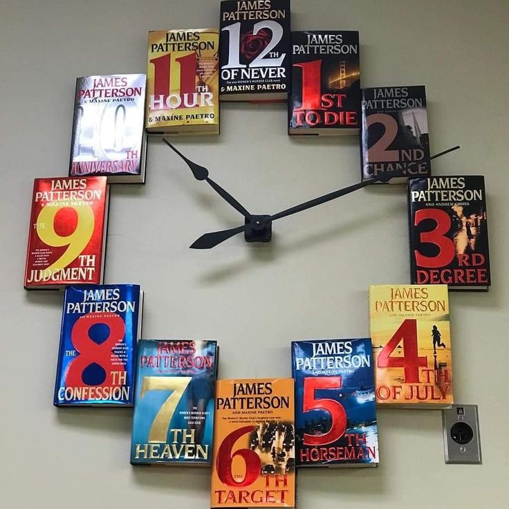 a clock made out of books on the wall