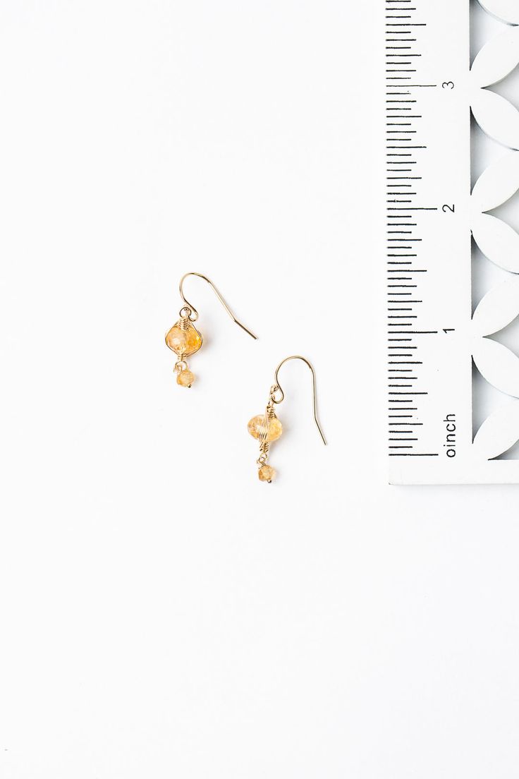 A beautiful gift for those born in November, featuring their birthstone of stunning citrine that is hand wrapped in a gold filled herringbone weave. These elegant earrings dangle from gold filled ear wires. Gold Filled (lead and nickel free) Citrine 1", on gold filled ear wires We hand select our natural materials, thus there may be slight variations in color and/or size that will not detract from the overall aesthetic Our unique handcrafted designer jewelry for women is made in America, with ea Gold Dangle Birthstone Jewelry, Gold Birthstone Dangle Jewelry, Gold Citrine Birthstone Jewelry, Handmade Dainty Gold Crystal Earrings, Gold Briolette Crystal Earrings With Ear Wire, Adjustable Yellow Gold Jewelry With Ear Wire, Gold Citrine Wire Wrapped Jewelry, Gold Wire-wrapped Citrine Jewelry, Gold Wire Wrapped Citrine Jewelry