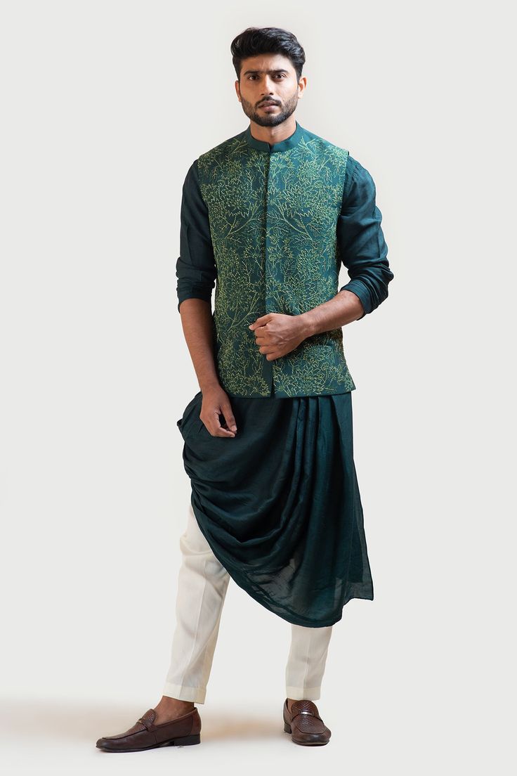 Moss green nehru jacket in bam silk with embroidery work. Paired with emerald green kurta with cascading pleat drapes. Comes with contrast white pant. 
Component: 3
Embroidered
Neckline: Mandarin
Sleeve Length: Jacket: Sleeveless; Kurta: Full
Fabric: Bam Silk; Pant: Malai Cotton
Color: Green
Contrast embroidered jacket
Front closure jacket
Side slit jacket
Front potli button placket kurta - Aza Fashions Nehru Jacket For Men, Green Drapes, Pleated Drapes, Vacuum Storage, Nehru Jacket, Nehru Jackets, Pants Cotton, Embroidered Neckline, Silk Pants